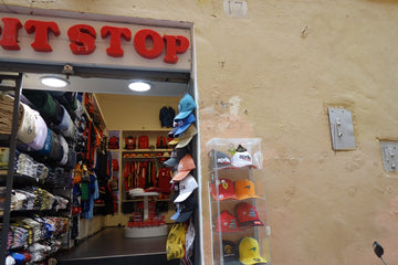 A small shop selling hats and bags