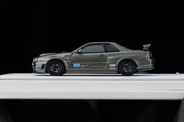 A grey sports car with racing decals on display.