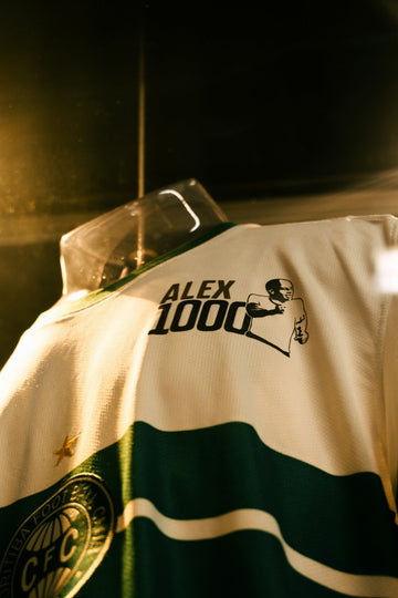 A white and green jersey with alex 1000 logo