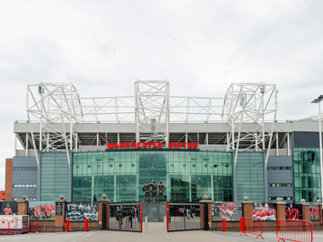 Modern stadium entrance with large glass windows and signage