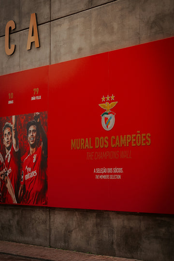 Red wall with football team emblem and player photos.