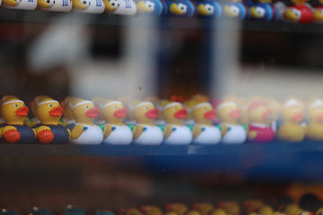 Row of yellow rubber ducks with various outfits