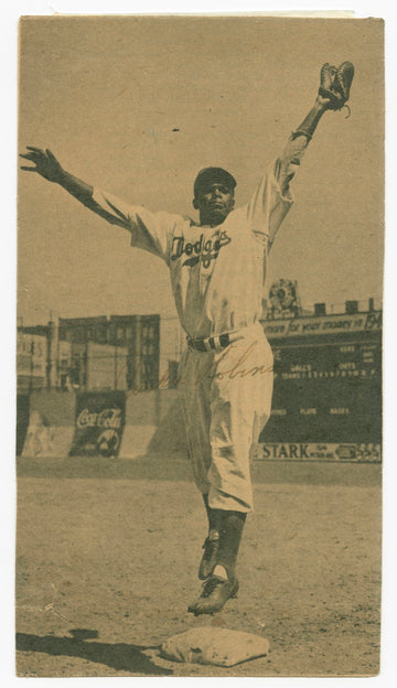 Baseball player jumping to catch ball at home plate.