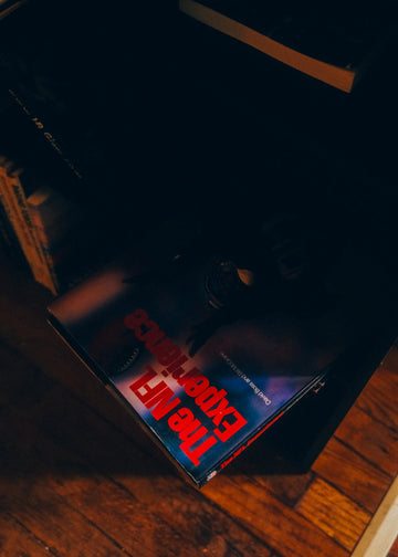 A dark corner with a book titled the NFL experience.