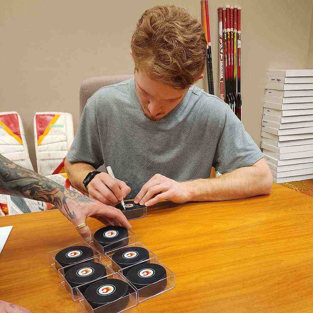 Dustin Wolf autographed hockey puck draft pick 214th 2019